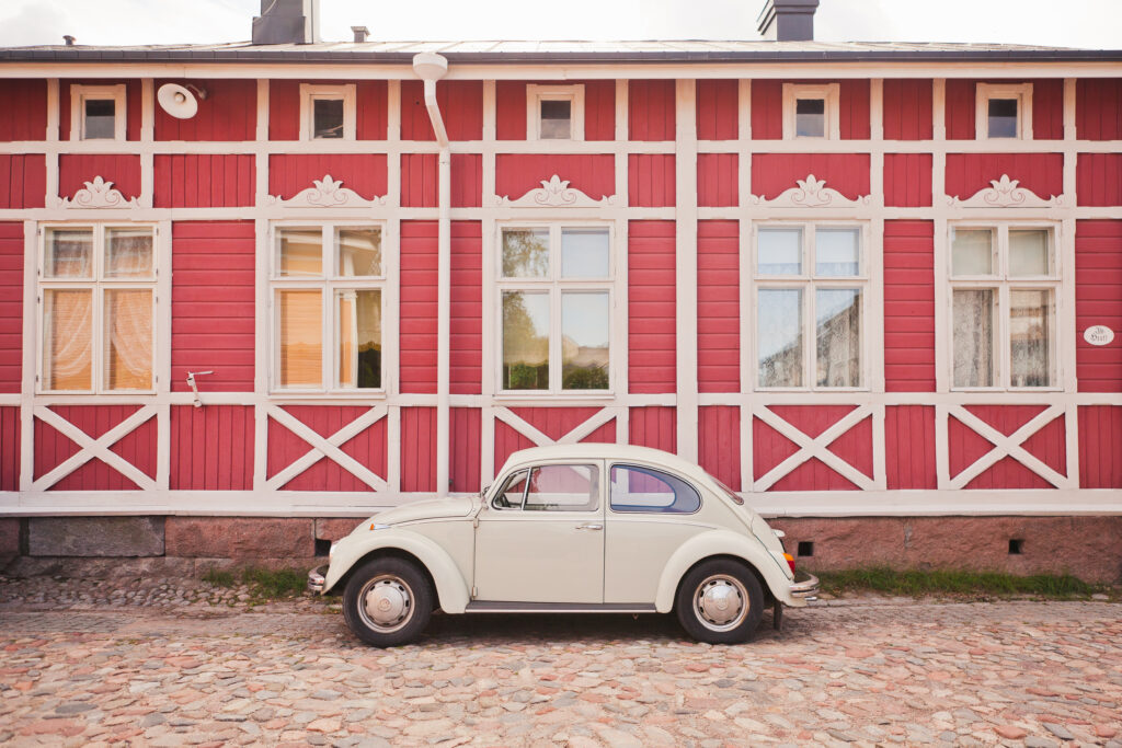 An old Wolkswagen car next to a building in Old Rauma