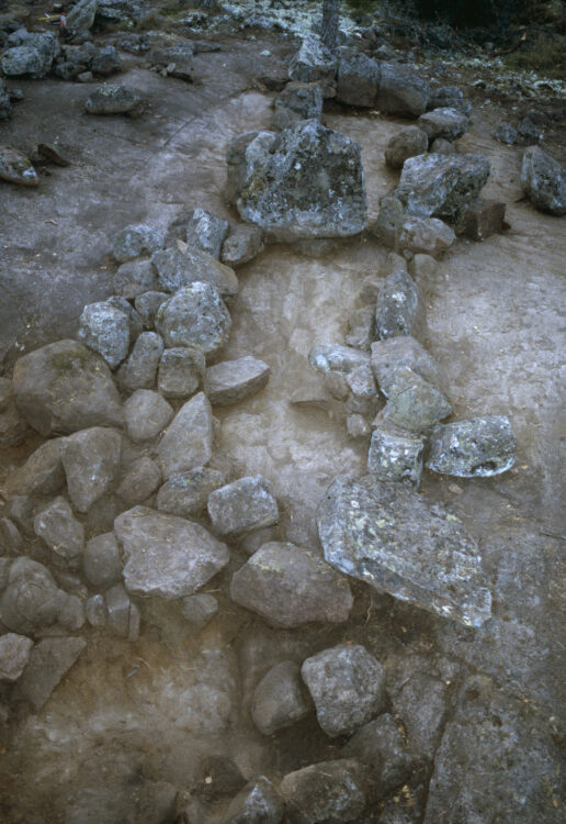 The picture shows two rectangular structures built of stones, with larger vertical stones at the ends, and a shared end stone in the middle.
