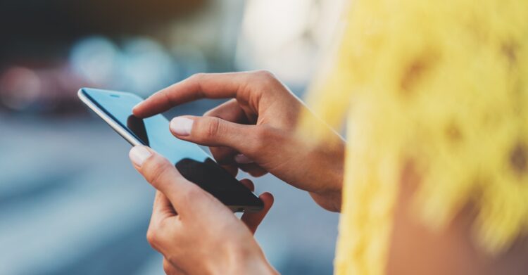 A person using a phone in their hands.