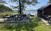 Karttu café's yard in Reksaari island and a charter cruiser Simba on the dock.