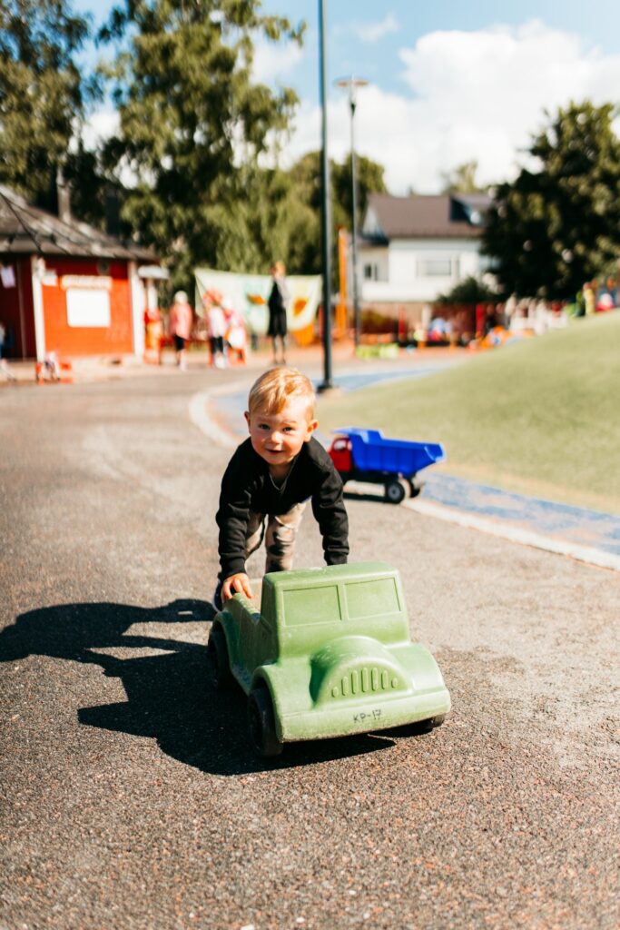 Child playing with a toy car in the traffic park.