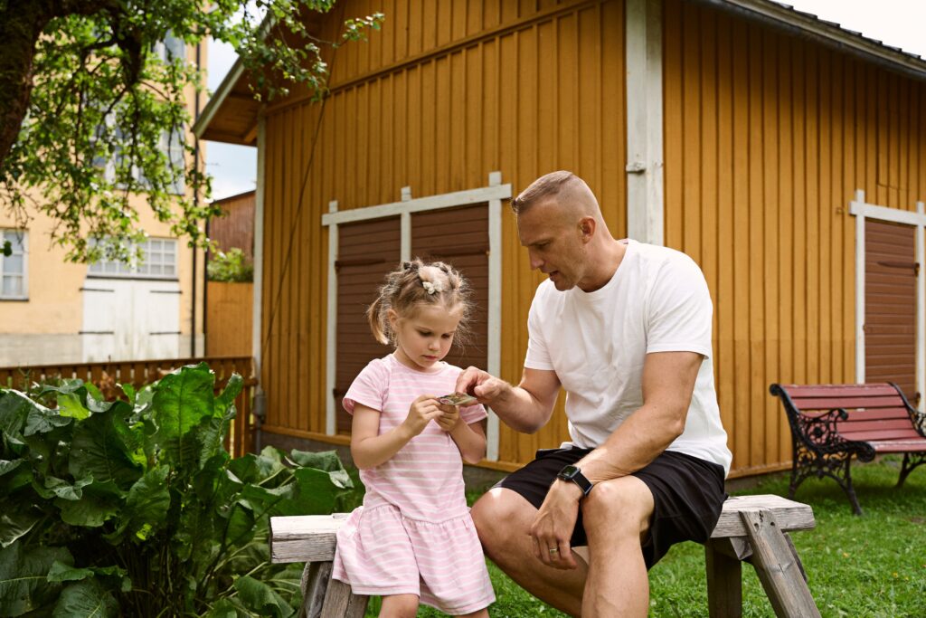 A father and a child in Kirsti Museum's yard.