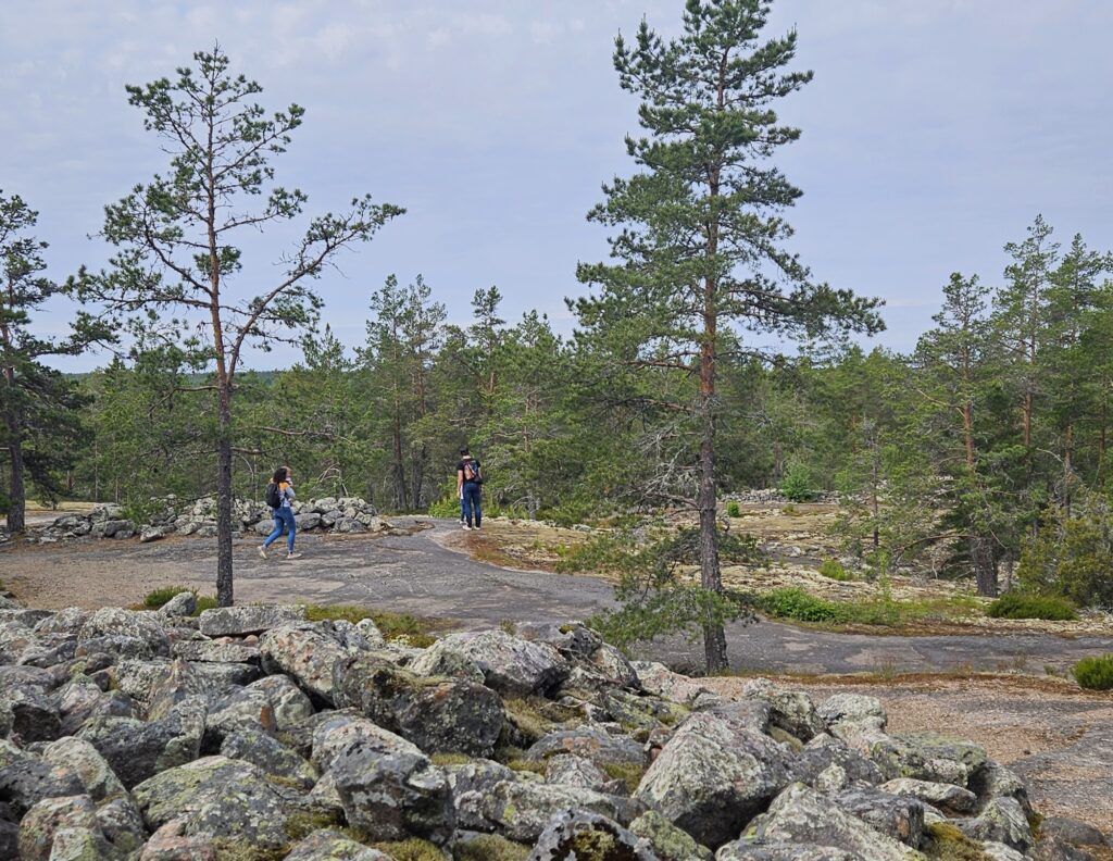 A view from the route in Sammallahdenmäki.  A family walking in the background. 