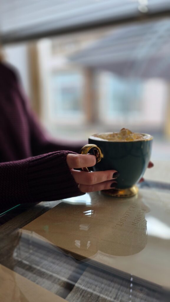 Hands holding a coffee cup.