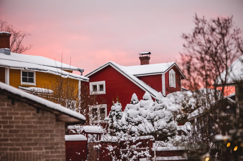 Old Rauma houses with snow and pink sky.