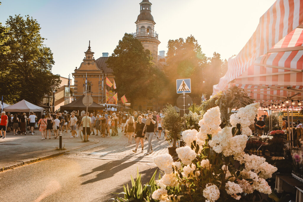 People walking in a market during Lace Week.